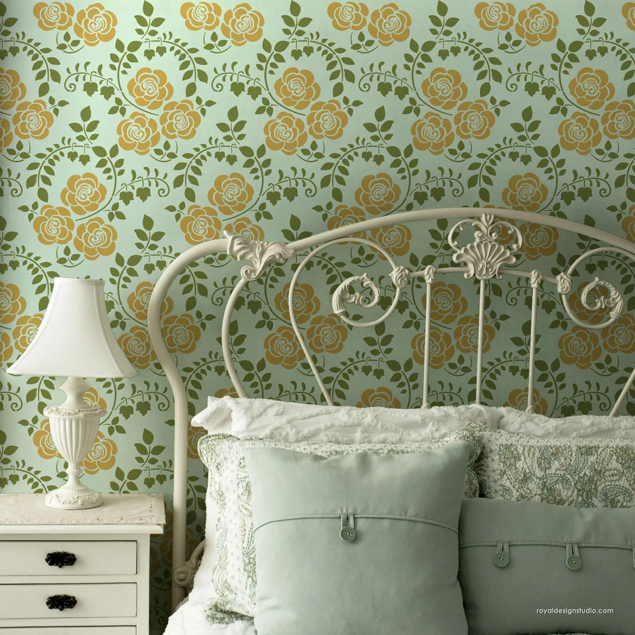 Floral Art Nouveau Stencil on a bedroom wall with antique iron bed